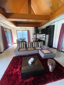 a living room with a couch and a red rug at Lris villas in Phuket Town
