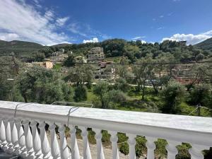 a white fence with a view of a city at angels apartments in Parga