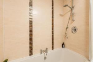 a bathroom with a shower and a bath tub at In the heart of Cardiff City Centre in Cardiff +24 photos