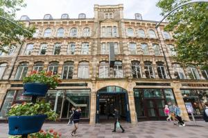 a large building with people walking in front of it at In the heart of Cardiff City Centre in Cardiff