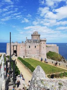 a castle with a bunch of people standing in front of it at ibis Saint Brieuc Yffiniac in Yffiniac