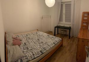 a bedroom with a bed with a teddy bear on it at Apartament Wyszyńskiego 32m16 in Kalisz