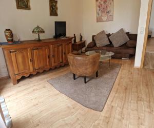 a living room with a couch and a table at Ferienwohnung Fellnasen WG 2 in Krefeld