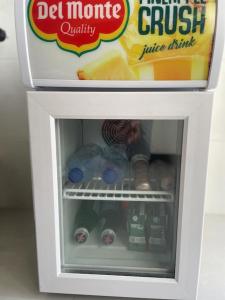 a small refrigerator with a box of juice drink at Mini luxury suite Ortea in Siracusa