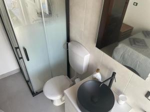 a bathroom with a toilet and a sink and a shower at Mini luxury suite Ortea in Siracusa