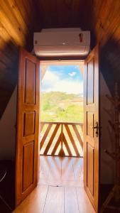 an open door to a balcony with a view at Pousada Chalés Olaria - Exclusiva para Casais in Tiradentes