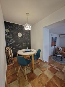 a dining room with a table and chairs and a chalkboard at Max's downtown oasis in Zadar
