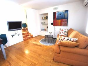 a living room with a couch and a television at Max's downtown oasis in Zadar