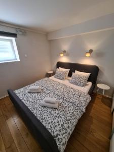 a bedroom with a bed with two towels on it at Max's downtown oasis in Zadar