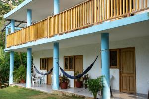 a house with a porch with a hammock on it at Villa Jaymar in Arboletes