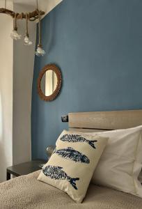 1 dormitorio con paredes azules y 1 cama con almohadas en La Piramide, en Manarola