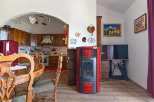 a kitchen with a living room with a stove in it at Casa Andrea in Mošćenička Draga