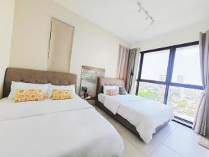 a bedroom with two beds and a large window at Urban Suites Georgetown New Condo City View 158 in Jelutong