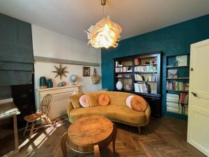 a living room with a couch and a table at B&B Nathalie in Bayeux