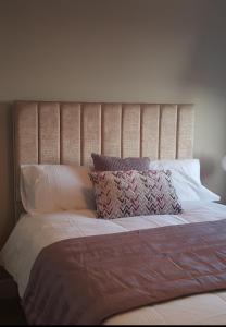 a large bed with white sheets and pillows at LaRambla Alicante City 3 Bdrm in Alicante
