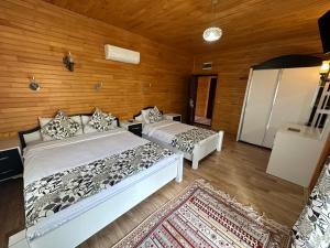 a bedroom with two beds and a couch at Palm Konak Hotel in Cıralı