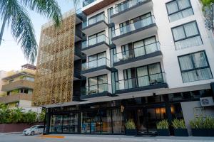 a building with a large building with windows at IT Boutique Hotel & Restaurant in Playa del Carmen