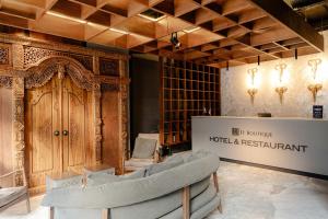 a showroom with a couch and a wooden door at IT Boutique Hotel & Restaurant in Playa del Carmen