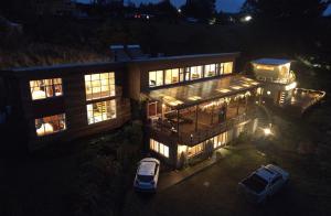 a large building with cars parked in front of it at night at Hotel Boutique Antukenu in Achao