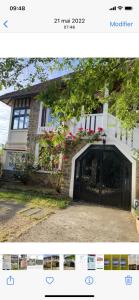 a picture of a house with a garage at Maison de Charme in Champs-Sur-Marne