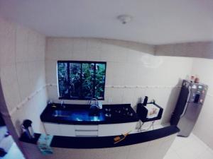 a small kitchen with a sink and a window at Casa do Aventureiro Holiday Home in Abraão