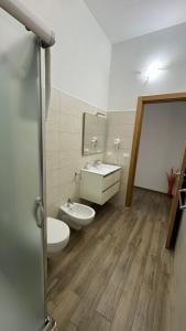 a bathroom with two toilets and a sink at Carpentry in Uggiano la Chiesa +38 photos