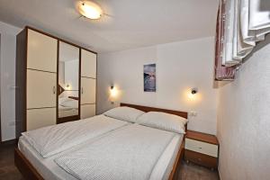 Postel nebo postele na pokoji v ubytování Tomic Apartments + 37 fotografií