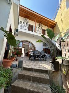 a patio with a table and chairs in a building at MAGIC MOON guest house in Famagusta