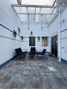 an empty room with chairs and tables in a building at Apartamento Sofía I a 500m de la Playa con Parking solo para motos y bicicletas in Puerto de Sagunto