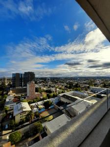 a view of a city from a balcony at Tu hogar lejos de casa in Chillán +5 photos