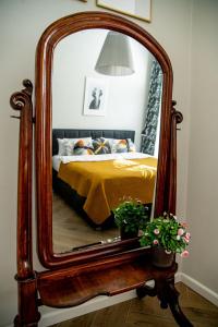 a bedroom with a large mirror on a bed at Brokilon House in Krakow