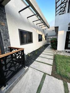 a walkway in front of a building with a bench at Fully Furnished 1 Bedroom House in Accra