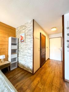 a room with a brick wall and a door at 4- Joli studio Brides-les-Bains avec vue montagne in Brides-les-Bains