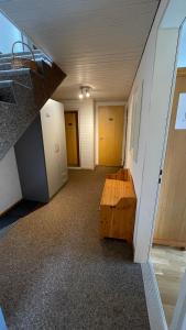 an empty room with a wooden table and doors at Zimmer in den Voralpen in Grub