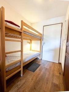 a bedroom with two bunk beds and a doorway at 5- Brides-les-Bains Studio de charme avec vue montagne in Brides-les-Bains