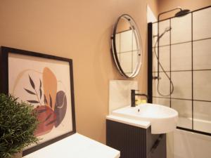 a bathroom with a sink and a mirror at Apartment 6 Old Conservative Club in Historic Town Pass the Keys in Caernarfon +45 photos
