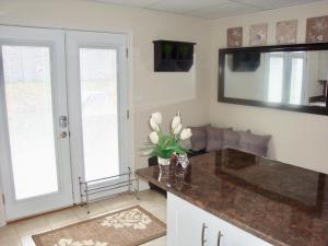 a kitchen with a counter and a mirror at Comfortable apartment in Kingston
