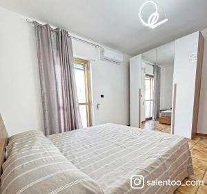 a bedroom with a large bed and a window at SeaBreeze - Torre San Giovanni in Torre San Giovanni Ugento