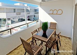 a table with chairs and a potted plant on a balcony at SeaBreeze - Torre San Giovanni in Torre San Giovanni Ugento