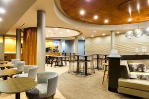a restaurant with tables and chairs and a bar at SpringHill Suites by Marriott McAllen Convention Center in McAllen