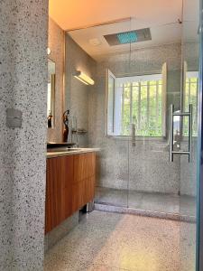 a bathroom with a glass shower and a sink at Villa familiale avec vue imprenable in Saint-Raphaël
