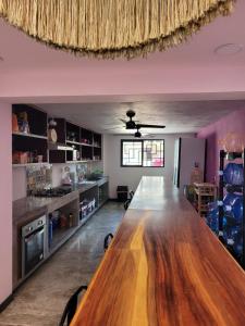 a kitchen with a large wooden table in a room at Itza Hotel Akumal - Dive House in Akumal