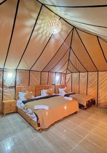 a bedroom with two beds in a tent at Explore merzouga luxury camp in Merzouga
