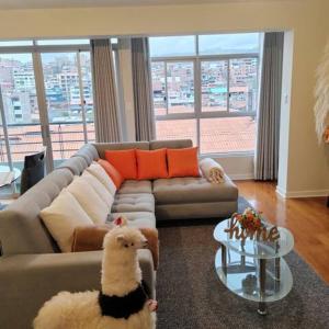 a living room with a couch with a toy dog on the floor at Elite Apartment 2 in Cusco