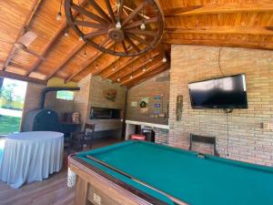 a room with a pool table and a tv at Don Patron hotel&eventos in Villarrica