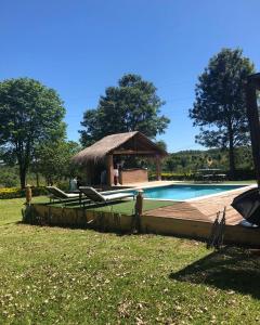 a swimming pool with a gazebo next to at Don Patron hotel&eventos in Villarrica