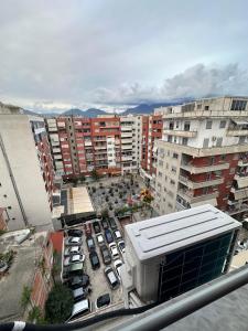 a view of a city with cars parked in a parking lot at Siart Apartment in Tirana