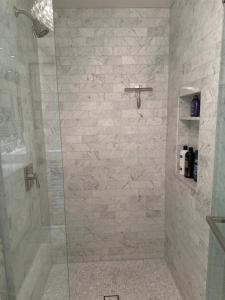 a bathroom with a shower with a stone wall at Luxury guest suite in Beverly Hills in Beverly Hills