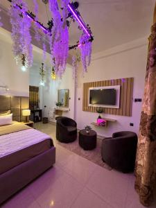 a bedroom with a bed and a tv and purple lights at Holiday Homes Guest Inn - Ella in Ella