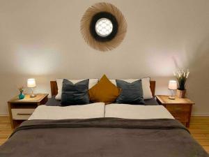 a bedroom with a large bed with a clock on the wall at Ferienwohnung Lieblingsplatz in Tholey